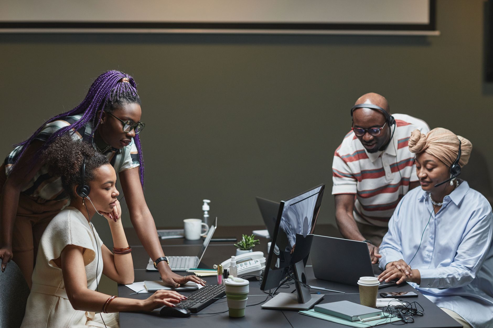 A team working together at laptops in a bright office